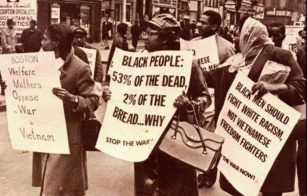 Picture of Black mothers holding protest signs in opposition against the Vietnam War