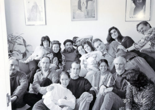 Photo of a dozen CEML activists in living room with Luis Talamantez