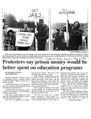 Newspaper clipping with text and photo of demonstrators on roadside