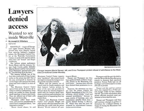Newspaper page with text and photo of two women in business dress examining papers outside
